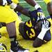 Michigan defensive tackle William Campbell laughs as he lies on the ground and is mobbed by teammates after Michigan beat Northwestern 38-31 in overtime at Michigan Stadium on Saturday. Melanie Maxwell I AnnArbor.com